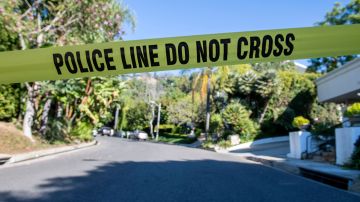 A Yellow Police tape blocks access to the 1100 block of Maytor place where Jacqueline Avant's house is at the top of the hill, in Beverly Hills , California on December 1, 2021. - The wife of the man known as the "Godfather of Black Music" was shot and killed Wednesday in a break-in at the couple's Beverly Hills home, US media reported. Jacqueline Avant died after being shot by a burglar, who also opened fire on a security guard, according to tabloid website TMZ. (Photo by VALERIE MACON / AFP) (Photo by VALERIE MACON/AFP via Getty Images)