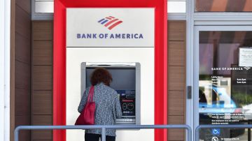 A woman uses a Bank of America ATM machine in Alhambra, California on May 4, 2022. - The US central bank announced its biggest interest rate hike in over twenty years as it deals with fast rising prices in the US economy. (Photo by Frederic J. BROWN / AFP) (Photo by FREDERIC J. BROWN/AFP via Getty Images)