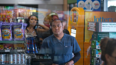 People wait in line to buy their Mega Millions lottery tickets at a 7-Eleven convenience store in Chino Hills, California, July 28, 2022. - The odds of claiming this week's bonanza US lottery prize are less than one-in-300-million -- but one "lucky" convenience store outside Los Angeles is already counting its winnings. A sign above the counter of the otherwise unassuming shop in California's Chino Hills proclaims itself the "LUCKIEST 7-ELEVEN IN THE WORLD," six years after it sold a winning ticket for the largest jackpot in US lottery history. (Photo by RINGO CHIU / AFP) (Photo by RINGO CHIU/AFP via Getty Images)