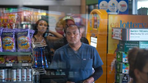 People wait in line to buy their Mega Millions lottery tickets at a 7-Eleven convenience store in Chino Hills, California, July 28, 2022. - The odds of claiming this week's bonanza US lottery prize are less than one-in-300-million -- but one "lucky" convenience store outside Los Angeles is already counting its winnings. A sign above the counter of the otherwise unassuming shop in California's Chino Hills proclaims itself the "LUCKIEST 7-ELEVEN IN THE WORLD," six years after it sold a winning ticket for the largest jackpot in US lottery history. (Photo by RINGO CHIU / AFP) (Photo by RINGO CHIU/AFP via Getty Images)