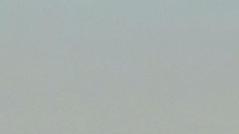 Snow-capped mountains are seen in the distance behind the downtown skyline on March 2, 2023 in Los Angeles, California where a new cold system brought hail and snow to unusually low elevations for the mountains in Southern California. (Photo by Frederic J. BROWN / AFP) (Photo by FREDERIC J. BROWN/AFP via Getty Images)