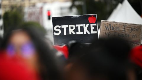 Los Angeles public school support staff, teachers, and supporters rally outside of the school district headquarters on the first day of a three day strike in Los Angeles, California, on March 21, 2023. - More than 500,000 children were shut out of lessons Tuesday as school workers in Los Angeles began a three-day walkout over pay. Bus drivers, cafeteria workers and special education assistants employed by Los Angeles Unified School District -- the second biggest in the United States -- are striking over what they say are "poverty wages." (Photo by Robyn BECK / AFP) (Photo by ROBYN BECK/AFP via Getty Images)