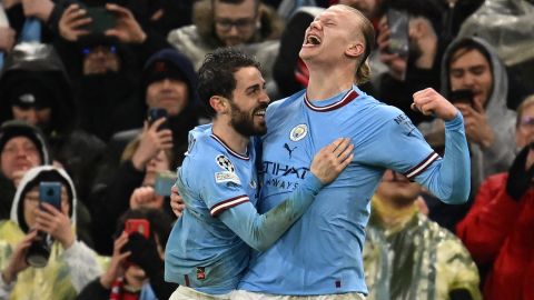 TOPSHOT - Manchester City's Norwegian striker Erling Haaland (R) celebrates with Manchester City's Portuguese midfielder Bernardo Silva (L) after scoring their third goal during the UEFA Champions League quarter final, first leg football match between Manchester City and Bayern Munich at the Etihad Stadium in Manchester, north-west England, on April 11, 2023. (Photo by Paul ELLIS / AFP) (Photo by PAUL ELLIS/AFP via Getty Images)