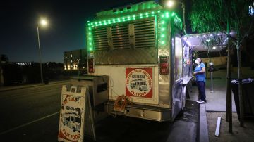 LOS ANGELES, CALIFORNIA - JULY 01: A customer orders from a taco truck amid the COVID-19 pandemic on July 1, 2020 in Los Angeles, California. California Governor Gavin Newsom ordered indoor dining restaurants to close again today in Los Angeles County and 18 other counties for at least three weeks amid a surge in new coronavirus cases. Restaurants and food trucks may remain open for takeout and drive-through orders. (Photo by Mario Tama/Getty Images)