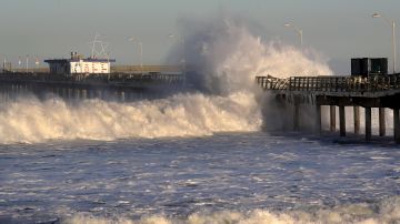 SAN DIEGO, CALIFORNIA - JANUARY 11: Large waves hit the Ocean Beach Pier causing minor damage as high surf advisories were in effect along San Diego beaches on January 11, 2021 in San Diego, California. The high surf advisories remain in effect until mid-day January 12, 2021. (Photo by Sean M. Haffey/Getty Images)