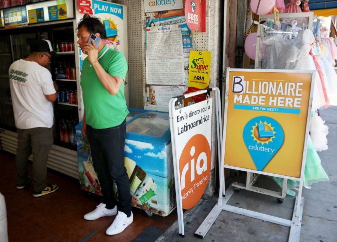 LOS ANGELES, CALIFORNIA - JULY 20: People gather in Las Palmitas Mini Market on July 20, 2023 in Los Angeles, California. The $1.08 billion winning Powerball ticket was sold at the Las Palmitas Mini Market for the July 19th drawing. The jackpot is the third largest in Powerball history and was picked after three months of drawings without a winner. The mini market is located in the downtown Fashion District close to Skid Row. (Photo by Mario Tama/Getty Images)