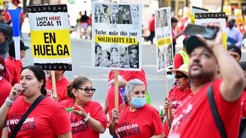 Hotel workers on strike hold placards calling on Taylor Swift to support their fight outside the InterContinental Hotel in downtown Los Angeles, California on August 7, 2023. Hundreds of hotel workers in Southern California walked off the job on Monday, demanding higher pay and better benefits. (Photo by Frederic J. BROWN / AFP) (Photo by FREDERIC J. BROWN/AFP via Getty Images)