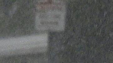 A vehicle splashes up water during heavy rains from Tropical Storm Hilary, in south Los Angeles, California, on August 20, 2023. Hurricane Hilary weakened to a tropical storm on August 20, 2023, as it barreled up Mexico's Pacific coast, but was still likely to bring life-threatening flooding to the typically arid southwestern United States, forecasters said. Authorities reported at least one fatality in northwestern Mexico, where Hilary lashed the Baja California Peninsula with heavy rain and strong winds. (Photo by Robyn BECK / AFP) (Photo by ROBYN BECK/AFP via Getty Images)
