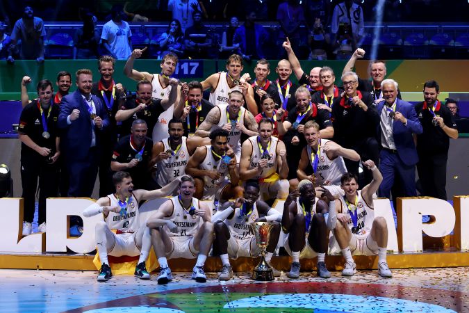 MANILA, PHILIPPINES - SEPTEMBER 10: Germany players, coaches and team officials pose for photos with the Naismith Trophy after the FIBA Basketball World Cup Final victory over Serbia at Mall of Asia Arena on September 10, 2023 in Manila, Philippines. Germany won 83-77.