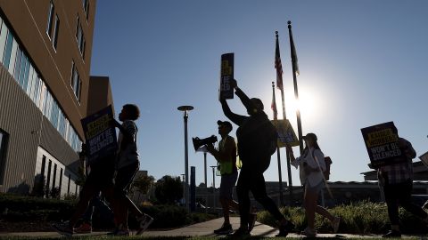 VALLEJO, CALIFORNIA - OCTOBER 06: Striking Kaiser Permanente workers hold signs as they march in front of the Kaiser Permanente Vallejo Medical Center on October 06, 2023 in Vallejo, California. More than 75,000 Kaiser Permanente workers continue to strike at hospitals and medical facilities in five states after labor negotiators could not reach an agreement to resolve a staffing level dispute. (Photo by Justin Sullivan/Getty Images)