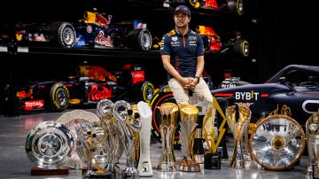 MILTON KEYNES, ENGLAND - DECEMBER 13: Sergio Perez of Mexico and Oracle Red Bull Racing poses for a photo with trophies during Max & Checo's Homecoming at Red Bull Racing Factory on December 13, 2023 in Milton Keynes, England. (Photo by Bob McCaffrey/Getty Images)