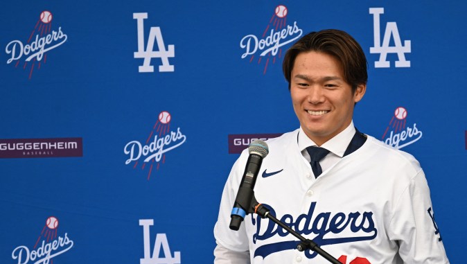 New Los Angeles Dodger, Japanese pitcher Yoshinobu Yamamoto smiles during his introductory press conference at Dodger Stadium in Los Angeles on December 27, 2023. The Los Angeles Dodgers confirmed their signing of Japanese pitcher Yoshinobu Yamamoto on December 27, formally introducing him a week after reports he had agreed to a 12-year, $325 million deal with the club. Yamamoto's arrival comes two weeks after the Dodgers inked two-way superstar Shohei Ohtani to a 10-year, $700 million deal. (Photo by Robyn Beck / AFP) (Photo by ROBYN BECK/AFP via Getty Images)