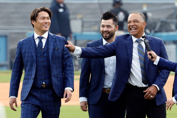 LOS ANGELES, CALIFORNIA - DECEMBER 27: Yoshinobu Yamamoto speaks with Manager Dave Roberts prior to an introductory press conference at Dodger Stadium on December 27, 2023 in Los Angeles, California. (Photo by Kevork Djansezian/Getty Images)