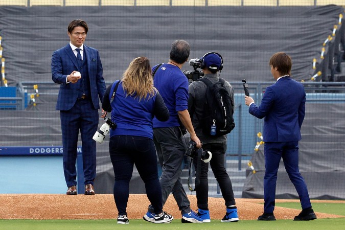LOS ANGELES, CALIFORNIA - DECEMBER 27: Yoshinobu Yamamoto poses for photos prior to an introductory press conference at Dodger Stadium on December 27, 2023 in Los Angeles, California. (Photo by Kevork Djansezian/Getty Images)