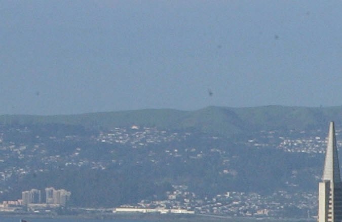SAN FRANCISCO - MARCH 25: Tourists take in a view of downtown San Francisco from Twin Peaks March 25, 2005 in San Francisco, California. San Francisco's 49-Mile Scenic Drive was opened in 1939 as a guide for visitors to The City's 1939-1940 Golden Gate International Exposition. The route includes most of San Francisco's major sights as well as winding through many of the city's colorful neighborhoods; giving visitors a look into the diversity and beauty of the area. (Photo by Justin Sullivan/Getty Images)