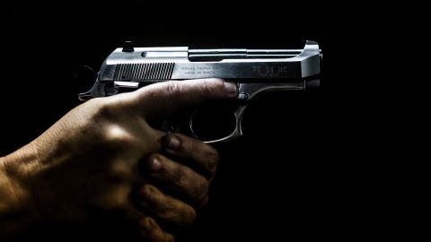 TOPSHOT - A man holds a gun at the 'Calibre 12' (Caliber 12) shooting club in Sao Goncalo, Rio de Janeiro, Brazil on September 03, 2018. The liberation of the use of firearms is one of Brazilian far-right presidential candidate Jair Bolsonaro's flagships. (Photo by DANIEL RAMALHO / AFP) (Photo by DANIEL RAMALHO/AFP via Getty Images)