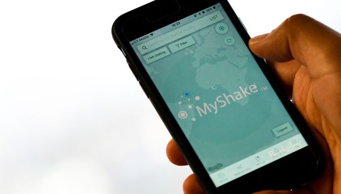 A person checks the "MyShake" app on their smartphone in Hollywood on October 17, 2019. - California on Thursday launched the country's first earthquake warning system in the hope that residents will be alerted within seconds of a possible impending disaster and can "drop, cover and hold on." (Photo by Chris Delmas / AFP) (Photo by CHRIS DELMAS/AFP via Getty Images)