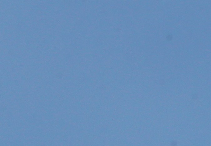 LOS ANGELES, CALIFORNIA - OCTOBER 21: A Los Angeles County Fire Department helicopter flies above firefighters positioned on a rooftop during the Palisades Fire, in the Pacific Palisades neighborhood, on October 21, 2019 in Los Angeles, California. The fire scorched at least 40 acres and threatened hillside homes. (Photo by Mario Tama/Getty Images)