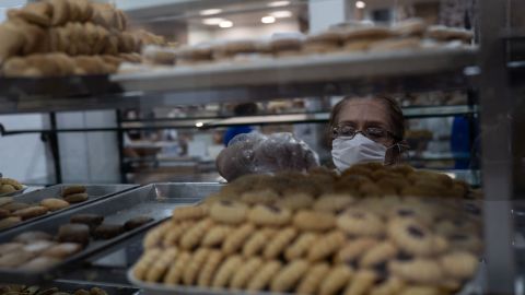 MEXICO CITY, MEXICO - MARCH 24: A bakery employee wearing a protective mask selects products during phase two of contingency measures to avoid the spread of COVID-19 on March 24, 2020 in Mexico City, Mexico. Beginning Monday, Mexico City ordered the closure of museums, bars, gyms, churches, theaters, with the exception of restaurants, in an attempt to contain COVID-19 pandemic. (Photo by Toya Sarno Jordan/Getty Images)