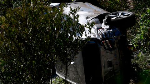 The vehicle driven by golfer Tiger Woods lies on its side in Rancho Palos Verdes, California, on February 23, 2021, after a rollover accident. - US golfer Tiger Woods was hospitalized Tuesday after a car crash in which his vehicle sustained "major damage," the Los Angeles County Sheriff's department said. Woods, the sole occupant, was removed from the wreckage by firefighters and paramedics, and suffered "multiple leg injuries," his agent said in a statement to US media. (Photo by Patrick T. FALLON / AFP) (Photo by PATRICK T. FALLON/AFP via Getty Images)