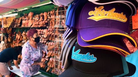 A vendor adjusts her display of shoes and sandals awaiting the return of more customers along Olvera Street in Los Angeles on June 14, 2021, one day before the state full reopening of its economy since the first statewide shutdown in March 2020 due to the coronavirus pandemic. - California is removing nearly all pandemic restrictions on June 15, with no mandatory capacity restrictions or social distancing requirements for those who have been vaccinated. (Photo by Frederic J. BROWN / AFP) (Photo by FREDERIC J. BROWN/AFP via Getty Images)