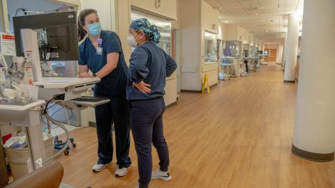 Healthcare workers are seen inside the Covid Intensive Care Unit in North Oaks Hospital in Hammond, Louisiana, on August 13, 2021. - Barely clinging to life, patients in an intensive care unit in Hammond, Louisiana, lie in their beds, gray and emaciated, their faces marked by the tight grip of respirators and the ravages of Covid-19. As cases soar due to the more contagious Delta variant, medical units like the North Oaks Hospital are overwhelmed. Half of the Covid patients there are critical. (Photo by Emily Kask / AFP) (Photo by EMILY KASK/AFP via Getty Images)