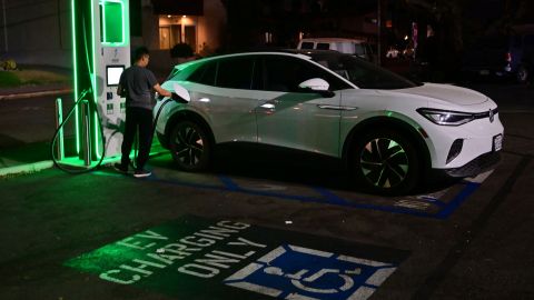 A driver charges his electric vehicle at a charging station as the California Independent System Operator announced a statewide electricity Flex Alert urging conservation to avoid blackouts in Monterey Park, California on August 31, 2022. - Californians were told August 31, 2022 not to charge their electric vehicles during peak hours, just days after the state said it would stop selling gas-powered cars, as the aging electricity grid struggles with a fearsome heatwave. Temperatures as high as 112 degrees Fahrenheit (44 degrees Celsius) were forecast in some Los Angeles suburbs as a huge heat dome bakes a swathe of the western United States. (Photo by Frederic J. BROWN / AFP) (Photo by FREDERIC J. BROWN/AFP via Getty Images)