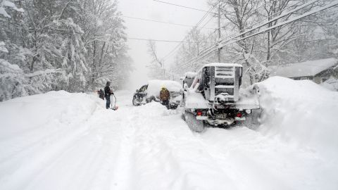 HAMBURG, NY - NOVEMBER 18: Good Samaritans help dig out a plow after an intense lake-effect snowstorm impacted the area on November 18, 2022 in Hamburg, New York. Around Buffalo and the surrounding suburbs, the snowstorm resulted in up to five feet of accumulation and additional snowfall is forecast for the weekend. The band of snow is expected to return to the same hard hit areas and has resulted in at least two deaths. (Photo by John Normile/Getty Images)