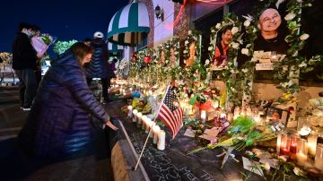 People pays their repect at a makeshift memorial for victims of a mass shooting in front of the Star Ballroom Dance Studio in Monterey Park, California on January 26, 2023. (Photo by Frederic J. BROWN / AFP) (Photo by FREDERIC J. BROWN/AFP via Getty Images)
