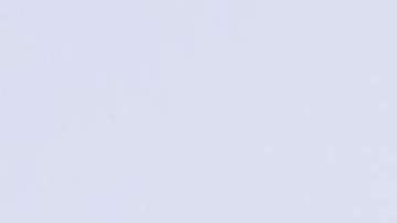 TOPSHOT - Houses sit below snow covered mountains in the Angeles National Forest in Sylmar, California, on February 25, 2023. - A major storm with a blizzard warning for parts of Southern California is expected to deliver damaging rain and snow at elevations lower than normal in Los Angeles County. (Photo by Allison Dinner / AFP) (Photo by ALLISON DINNER/AFP via Getty Images)