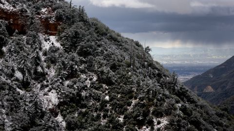 CLAREMONT, CALIFORNIA - FEBRUARY 23: A storm front passes while dropping precipitation as snow blankets the Angeles National Forest in Los Angeles County on February 23, 2023 near Claremont, California. A major storm, carrying a rare blizzard warning for parts of Southern California, is expected to deliver heavy snowfall to the mountains with some snowfall expected to reach lower elevations in L.A. County. (Photo by Mario Tama/Getty Images)