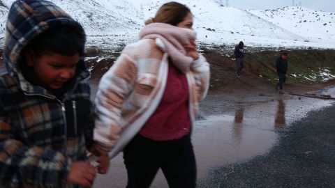 PALMDALE, CALIFORNIA - FEBRUARY 26: People depart after walking on a snow-covered hillside in Los Angeles County on February 26, 2023 near Palmdale, California. A major storm, which carried a rare blizzard warning for parts of Southern California, delivered heavy snowfall to the mountains with some snowfall reaching lower elevations in Los Angeles County. The National Weather Service called the storm 'one of the strongest ever' to impact southwest California as it also delivered widespread heavy rains and high winds. Southern California snowfall topped out at 6 feet at Mountain High with rain topping five inches at Cucamonga Canyon. (Photo by Mario Tama/Getty Images)