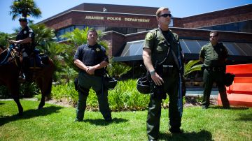 ANAHEIM, CA - JULY 29: A line of police officers guard the Anaheim Police Department before a protest to show outrage for the several recent officer-involved shootings on July 29, 2012 in Anaheim, California. For the past week, protesters have clashed with police resulting in both property damage and many arrests. (Photo by Jonathan Gibby/Getty Images)