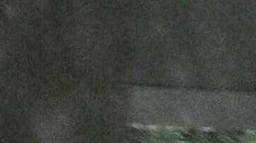 A person runs outside a gas station during heavy rains from Tropical Storm Hilary, in south Los Angeles, California, on August 20, 2023. Hurricane Hilary weakened to a tropical storm on August 20, 2023, as it barreled up Mexico's Pacific coast, but was still likely to bring life-threatening flooding to the typically arid southwestern United States, forecasters said. Authorities reported at least one fatality in northwestern Mexico, where Hilary lashed the Baja California Peninsula with heavy rain and strong winds. (Photo by Robyn BECK / AFP) (Photo by ROBYN BECK/AFP via Getty Images)