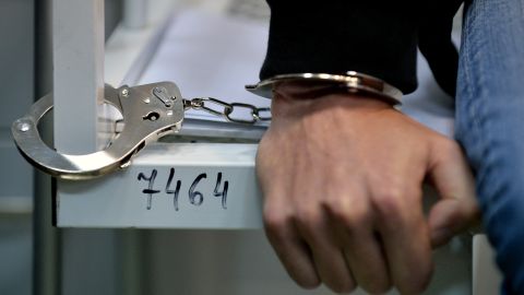 A view of the hand of one of three HIV-infected patients of the specialized Lavra hospital in Kiev who remain handcuffed to the steel frame of a bed as they start an unlimited protest against a government decision to force the closing and relocation of the HIV patients care unit, on September 12, 2013. The three patients and some employees of the unique Ukrainian hospital unit are protesting the Ukrainian government's decision to close the unit and relocate it outside of the city center saying the new location does not fit the standards for proper treatment. Ukraine has one of the fastest growing HIV/AIDS epidemics in the world. AFP PHOTO/ SERGEI SUPINSKY (Photo credit should read SERGEI SUPINSKY/AFP via Getty Images)