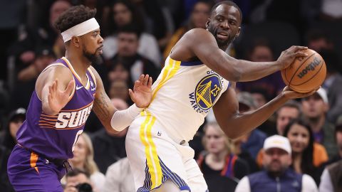 PHOENIX, ARIZONA - DECEMBER 12: Draymond Green #23 of the Golden State Warriors looks to pass under pressure from Jordan Goodwin #0 of the Phoenix Suns during the NBA game at Footprint Center on December 12, 2023 in Phoenix, Arizona. The Suns defeated the Warriors 119-116. NOTE TO USER: User expressly acknowledges and agrees that, by downloading and or using this photograph, User is consenting to the terms and conditions of the Getty Images License Agreement. (Photo by Christian Petersen/Getty Images)