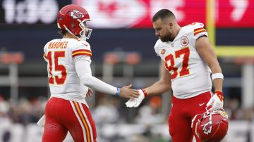 FOXBOROUGH, MASSACHUSETTS - DECEMBER 17: Patrick Mahomes #15 and Travis Kelce #87 of the Kansas City Chiefs high five during the first half against the New England Patriots at Gillette Stadium on December 17, 2023 in Foxborough, Massachusetts. (Photo by Sarah Stier/Getty Images)