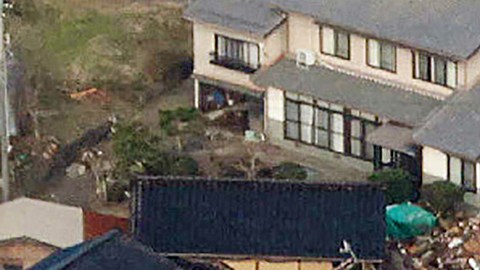 TOPSHOT - This aerial photo provided by Jiji Press shows smoke rising from a house fire (top R) along with other damage along the coast in the town of Noto, Ishikawa prefecture on January 2, 2024, a day after a major 7.5 magnitude earthquake struck the Noto region in Ishikawa prefecture. Japanese rescuers battled against the clock and powerful aftershocks on January 2 to find survivors of a major earthquake that struck on New Year's Day, killing at least 30 people and causing widespread destruction. (Photo by JIJI PRESS / AFP) / Japan OUT (Photo by STR/JIJI PRESS/AFP via Getty Images)