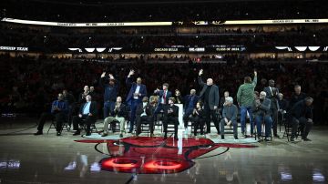 CHICAGO, ILLINOIS - JANUARY 12: The former players, coaches and managers wave to the crowd during the inaugural Ring of Honor ceremony for the 1995-1996 Chicago Bulls at the game between Golden State Warriors and Chicago Bulls at the United Center on January 12, 2024 in Chicago, Illinois. NOTE TO USER: User expressly acknowledges and agrees that, by downloading and or using this photograph, User is consenting to the terms and conditions of the Getty Images License Agreement. (Photo by Jamie Sabau/Getty Images)