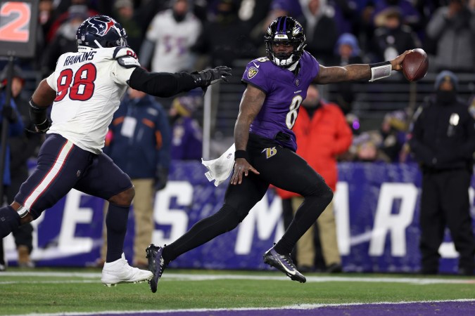 BALTIMORE, MARYLAND - JANUARY 20: Lamar Jackson #8 of the Baltimore Ravens scores an 8 yard touchdown against Sheldon Rankins #98 of the Houston Texans during the fourth quarter in the AFC Divisional Playoff game at M&T Bank Stadium on January 20, 2024 in Baltimore, Maryland. (Photo by Patrick Smith/Getty Images)