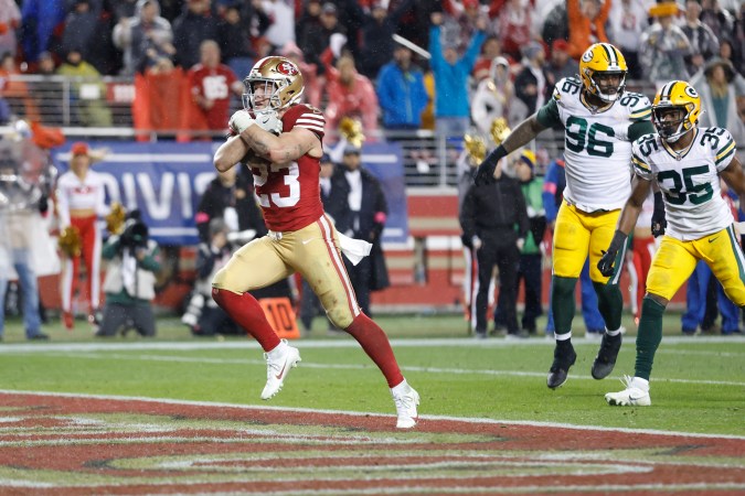 SANTA CLARA, CALIFORNIA - JANUARY 20: Christian McCaffrey #23 of the San Francisco 49ers rushes for a 6-yard touchdown during the fourth quarter against the Green Bay Packers in the NFC Divisional Playoffs at Levi's Stadium on January 20, 2024 in Santa Clara, California. (Photo by Lachlan Cunningham/Getty Images)