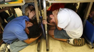 BURBANK, CA - NOVEMBER 13: Students of Stevenson Elementary School drop, cover and hold on during the region-wide simulation of an expected catastrophic 7.8 magnitude earthquake on the San Andreas Fault during the Great Southern California ShakeOut earthquake drill, the largest earthquake preparedness event in US history, on November 13, 2008 in the Los Angeles area city of Burbank, California. An estimated 5.2 million people in Southern California are expected to participate in the scenario in which 1,800 people die, 53,000 people are injured, 1,500 buildings collapse, 1,600 fires ignite, and $213 billion in damage are done by a quake 50 times more intense than the 1994 Northridge earthquake. Scientist believe that on average, a massive earthquake occurs south of the San Gabriel Mountains about every 150 years. The last one was at least 300 years ago. (Photo by David McNew/Getty Images)