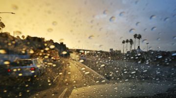 Rain from a storm cell soaks Pacific Coast Highway at it approaches the McClure Tunnel, left, near the pier in Santa Monica, Calif., right, as one of a series of storms sweeps through California Friday, Oct. 28, 2016. (AP Photo/Reed Saxon)