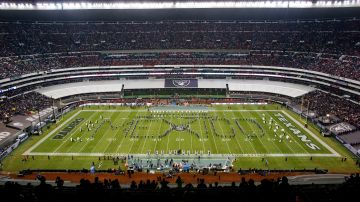 FILE - In this Nov. 21, 2016, file photo, performers spell out "Mexico" during the halftime presentation at the NFL football game between the Houston Texans and the Oakland Raiders in Mexico City. The NFL's final international game this season features the back-on-target Patriots and the disappointing Raiders on Sunday. It's the second straight year Oakland has given up a game in California to host one in Mexico City. (AP Photo/Dario Lopez-Mills, File)