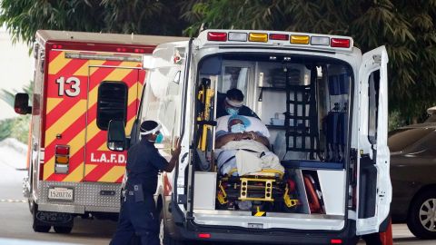 A patient is loaded onto an ambulance outside of the emergency entrance to PIH Health Good Samaritan Hospital Tuesday, Jan. 5, 2021, in Los Angeles. (AP Photo/Marcio Jose Sanchez)