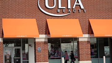 FILE - In this Nov. 5, 2020 file photo, women walk to an Ulta Beauty store in Schaumburg, Ill. Cosmetics retailer Ulta Beauty says it’s investing more than $25 million this year to improve diversity of its product mix and inclusion in its business practices. The plan announced Tuesday, Feb. 2, 2021, includes doubling the number of beauty products from Black-owned brands by year-end, though it declined to say the number. (AP Photo/Nam Y. Huh, File)