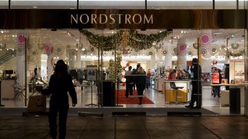 A security guard, right, stands at the entrance to a Nordstrom department store at the Grove mall in Los Angeles, Thursday, Dec. 2, 2021, where a recent smash-and-grab robbery took place. Prosecutors and retailers are pushing back on assertions by California’s governor and attorney general that they have enough tools to combat shoplifting. California Retailers Association president Rachel Michelin says shoplifting has been a growing problem.(AP Photo/Jae C. Hong)