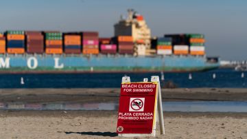 A beach closure sign is posted on Cabrillo Beach in the San Pedro section of Los Angeles, Monday, Jan. 3, 2022. Some Southern California beaches have reopened after a large sewage spill shut off large segment of the coastline before New Year's Day. (AP Photo/Jae C. Hong)