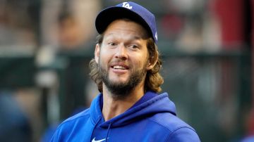 Los Angeles Dodgers starting pitcher Clayton Kershaw pauses in the dugout prior to Game 3 of a baseball NL Division Series against the Arizona Diamondbacks Wednesday, Oct. 11, 2023, in Phoenix. The Diamondbacks won 4-2. (AP Photo/Ross D. Franklin)