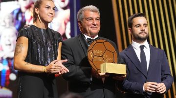 FC Barcelona president Joan Laporta, centre, player Patricia Guijarro, left, and women's team coach Jonatan Giraldez receive the Women's Club of the Year award during the 67th Ballon d'Or (Golden Ball) award ceremony at Theatre du Chatelet in Paris, France, Monday, Oct. 30, 2023. (AP Photo/Michel Euler)